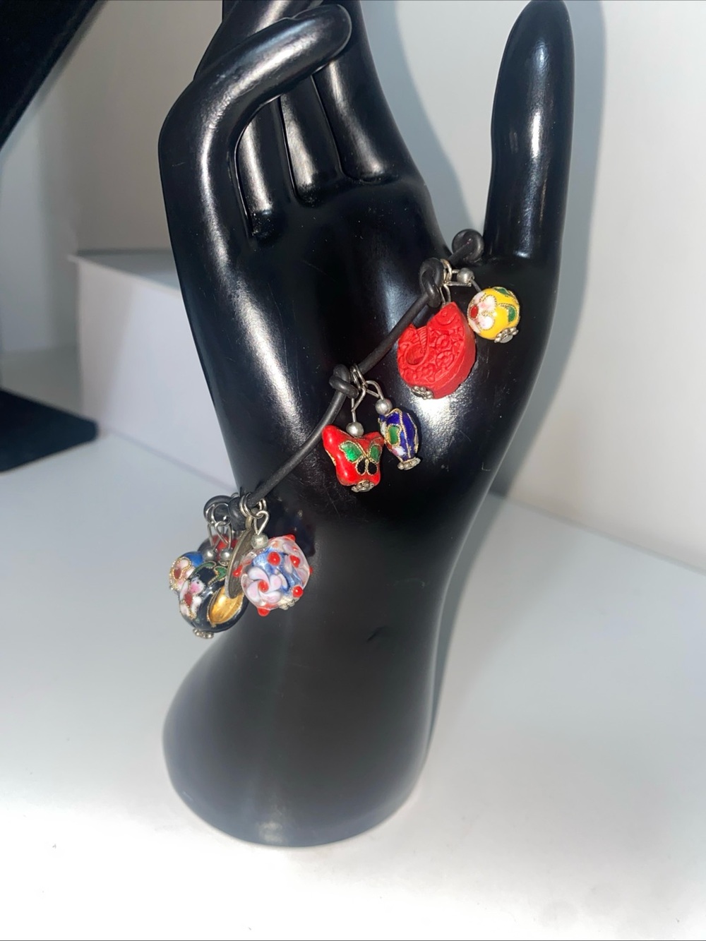 Bracelet leather colorful glass and cloisonné charms.